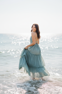 Dark-haired model wading in water
