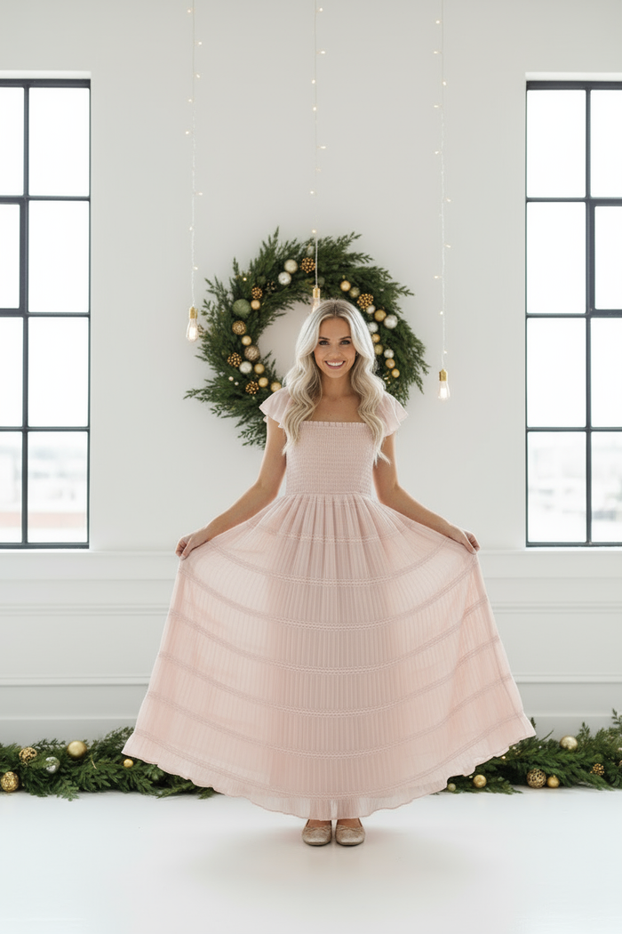 Mom holding out Marabella dress skirt in holiday setting