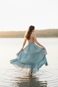 Standing in water at sunset